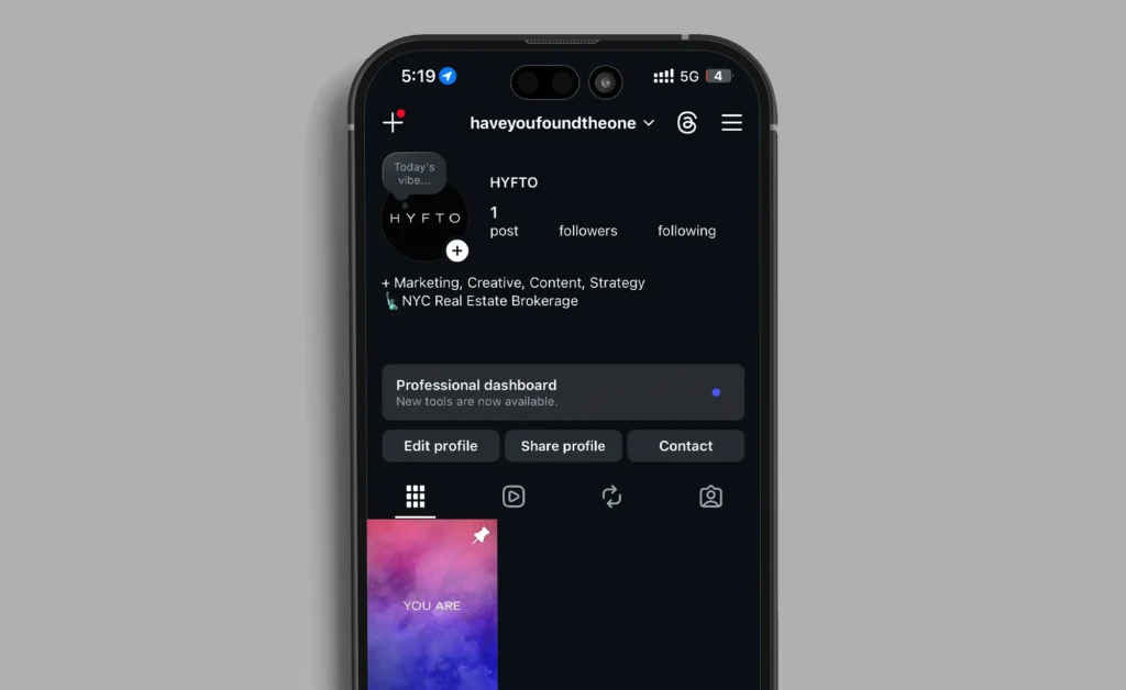 Smartphone open to Instagram on gray background.